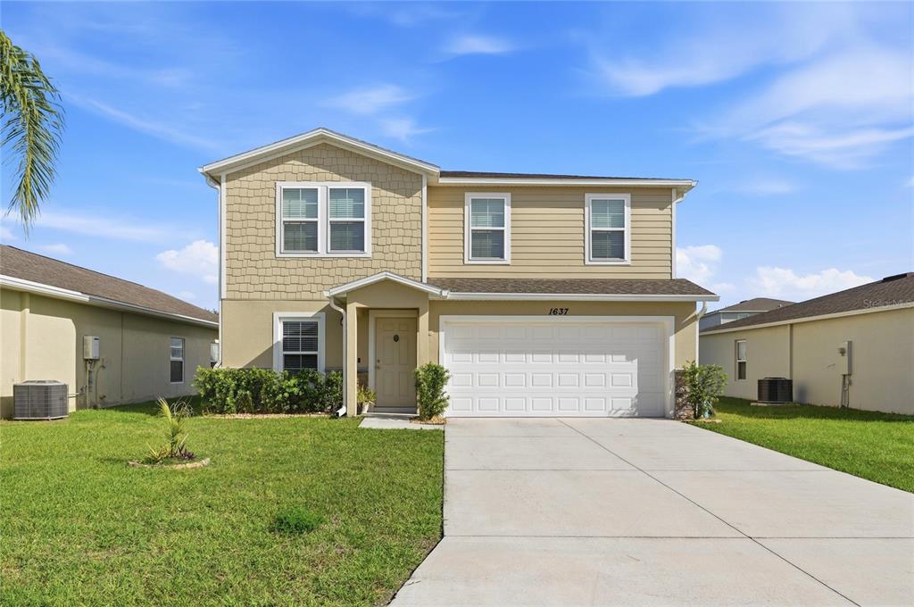 1637 Marble Street Sebring, FL 33870 - Photo 2 of 57 a front view of a house with a yard and garage
