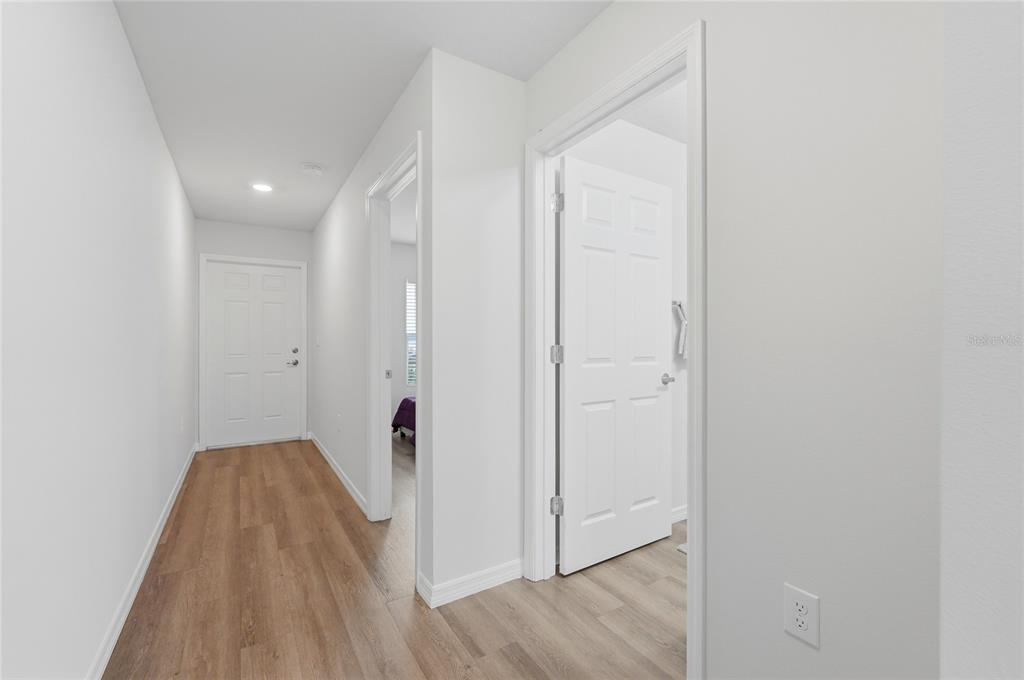 1637 Marble Street Sebring, FL 33870 - Photo 26 of 57 a view of a hallway with wooden floor and closet