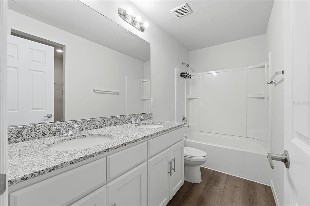 1637 Marble Street Sebring, FL 33870 - Photo 29 of 57 a bathroom with a granite countertop sink a toilet and shower