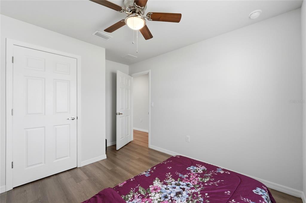1637 Marble Street Sebring, FL 33870 - Photo 35 of 57 an empty room with wooden floor and a chandelier fan