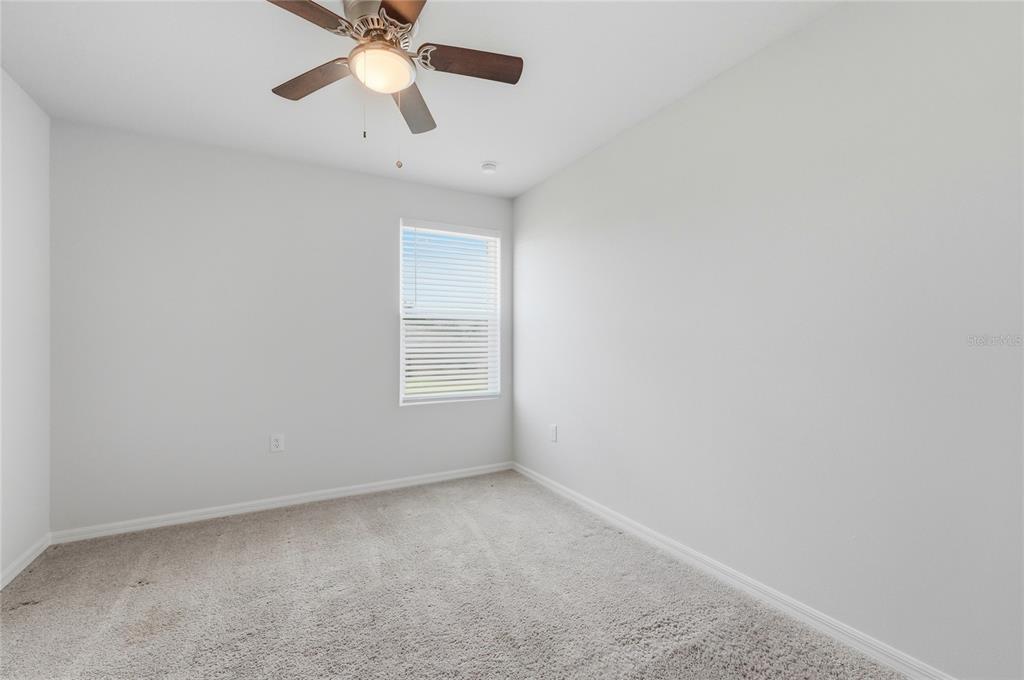 1637 Marble Street Sebring, FL 33870 - Photo 40 of 57 an empty room with a chandelier fan and windows
