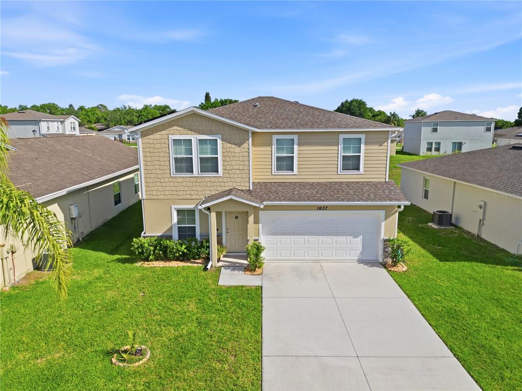1637 Marble Street Sebring, FL 33870 - Photo 4 of 57 a front view of a house with a yard
