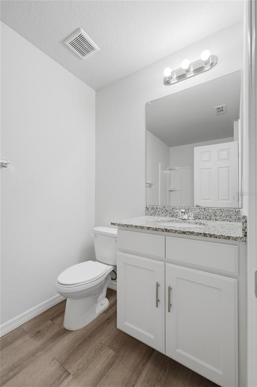 1637 Marble Street Sebring, FL 33870 - Photo 41 of 57 a bathroom with a granite countertop toilet a sink and a mirror