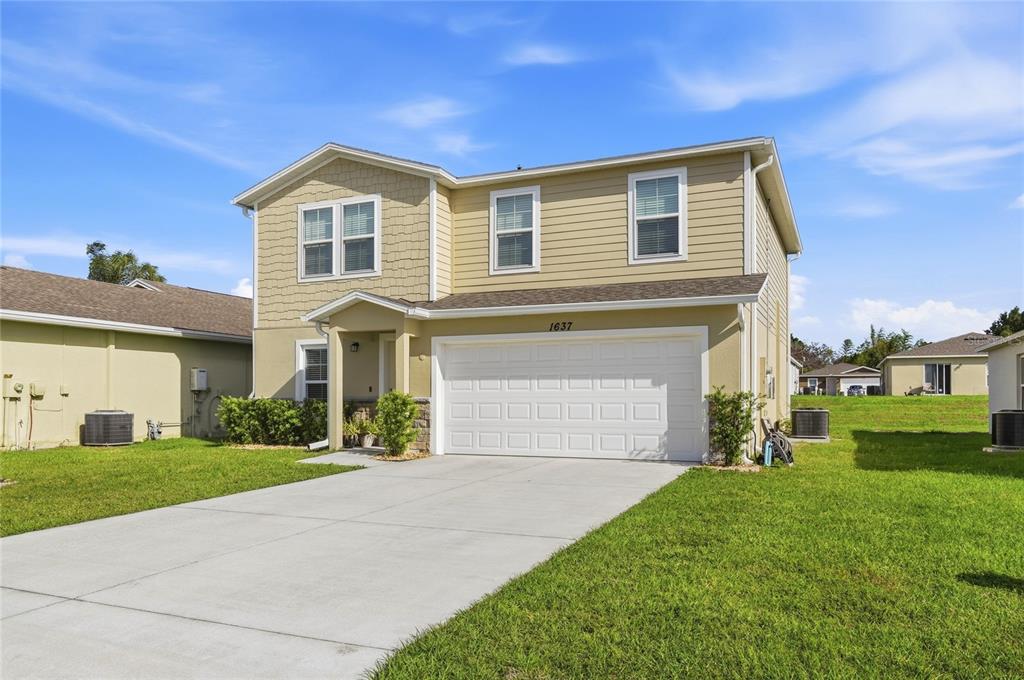 1637 Marble Street Sebring, FL 33870 - Photo 5 of 57 a front view of a house with a yard