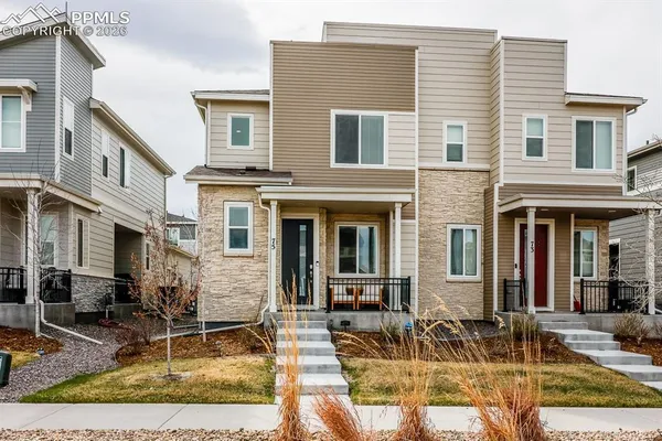 a front view of a house with many windows