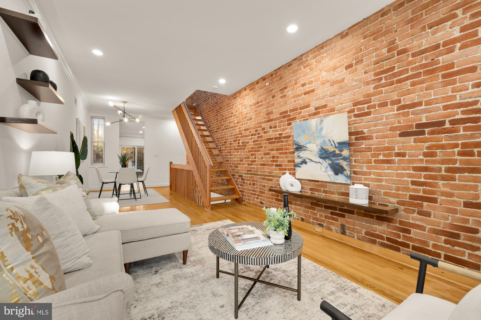 a living room with fireplace furniture and a rug