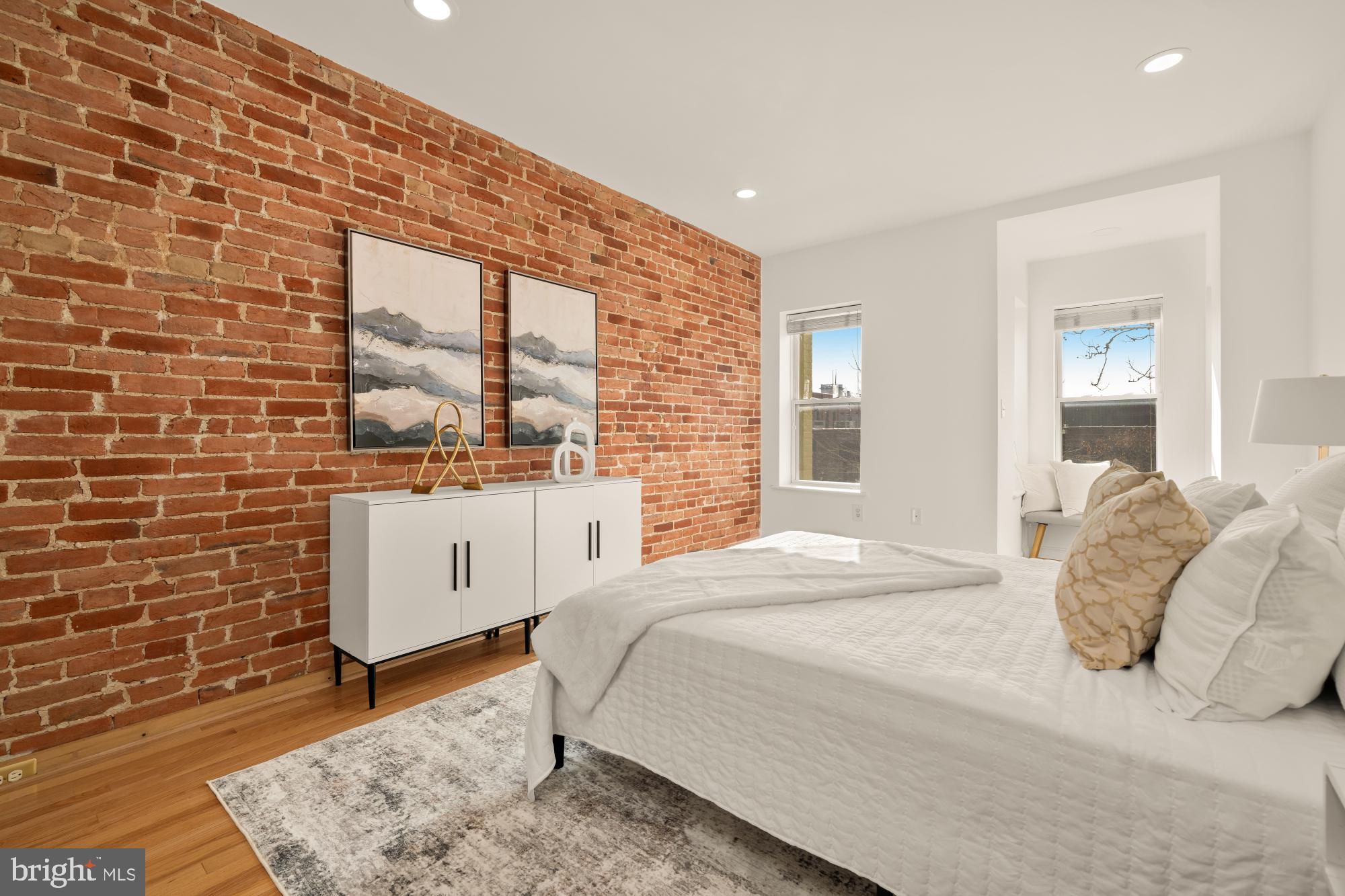 706 L Street Southeast Washington, DC 20003 - Photo 15 of 36 a large bed sitting in a bedroom next to a lamp