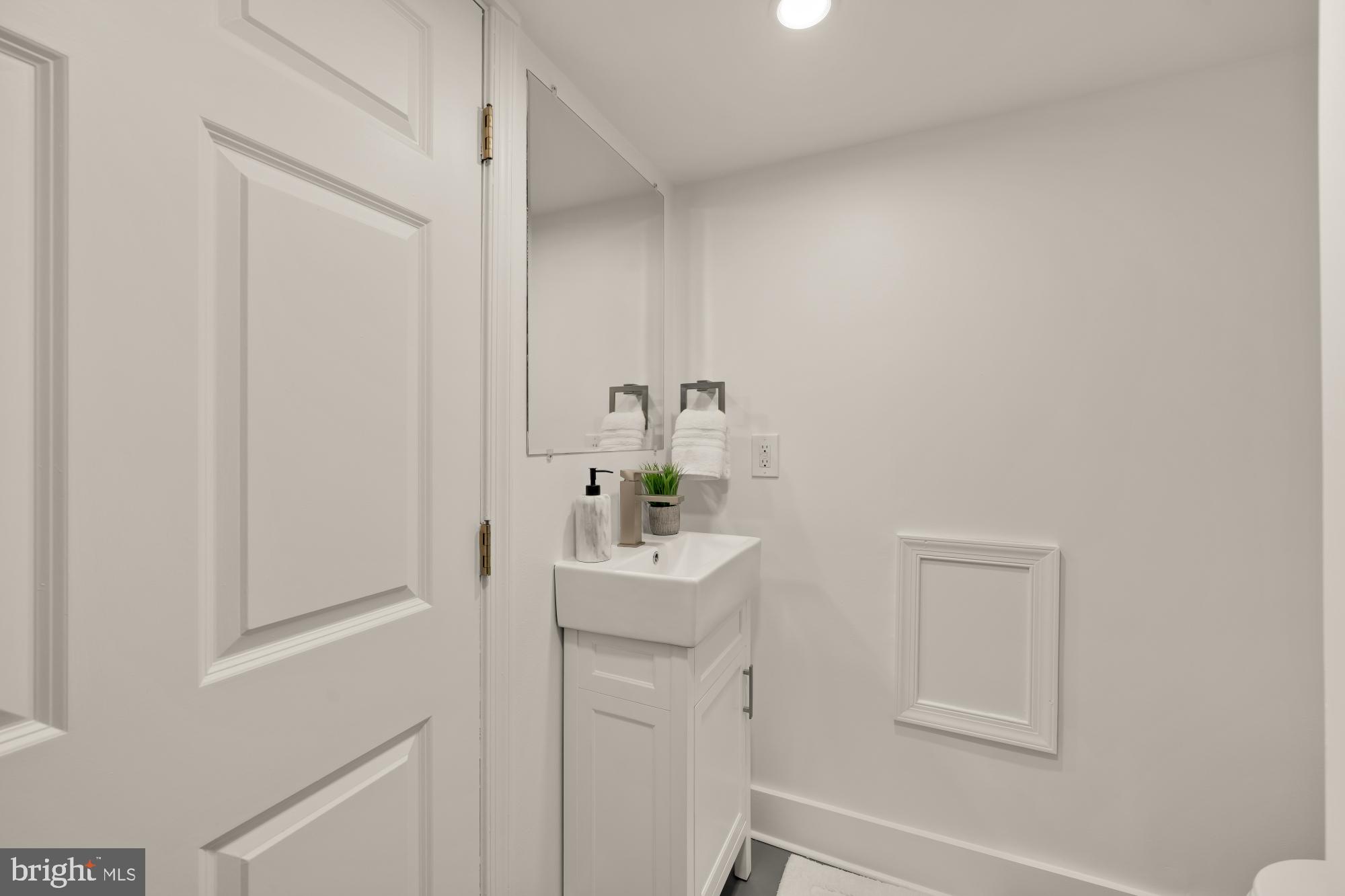 706 L Street Southeast Washington, DC 20003 - Photo 25 of 36 a bathroom with a sink mirror and vanity