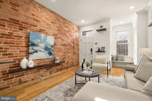 a living room with furniture wooden floor and a rug