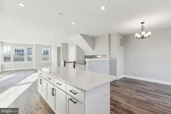 a open kitchen with stainless steel appliances granite countertop a lot of counter space and wooden floors