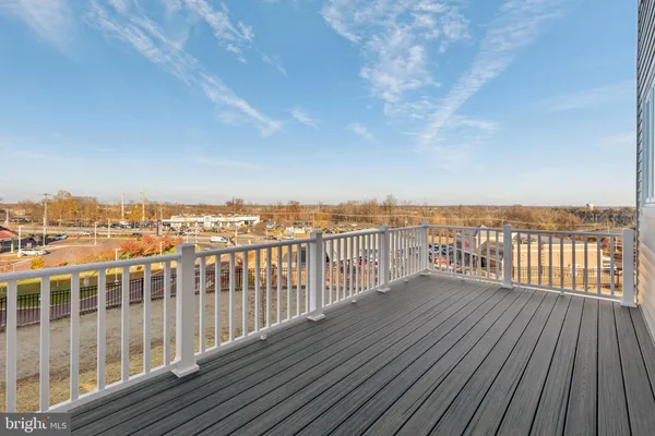 a balcony with wooden floor and city view