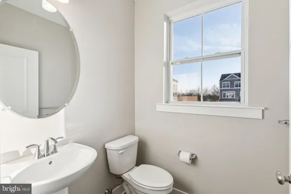 a white toilet sitting next to a bathroom sink