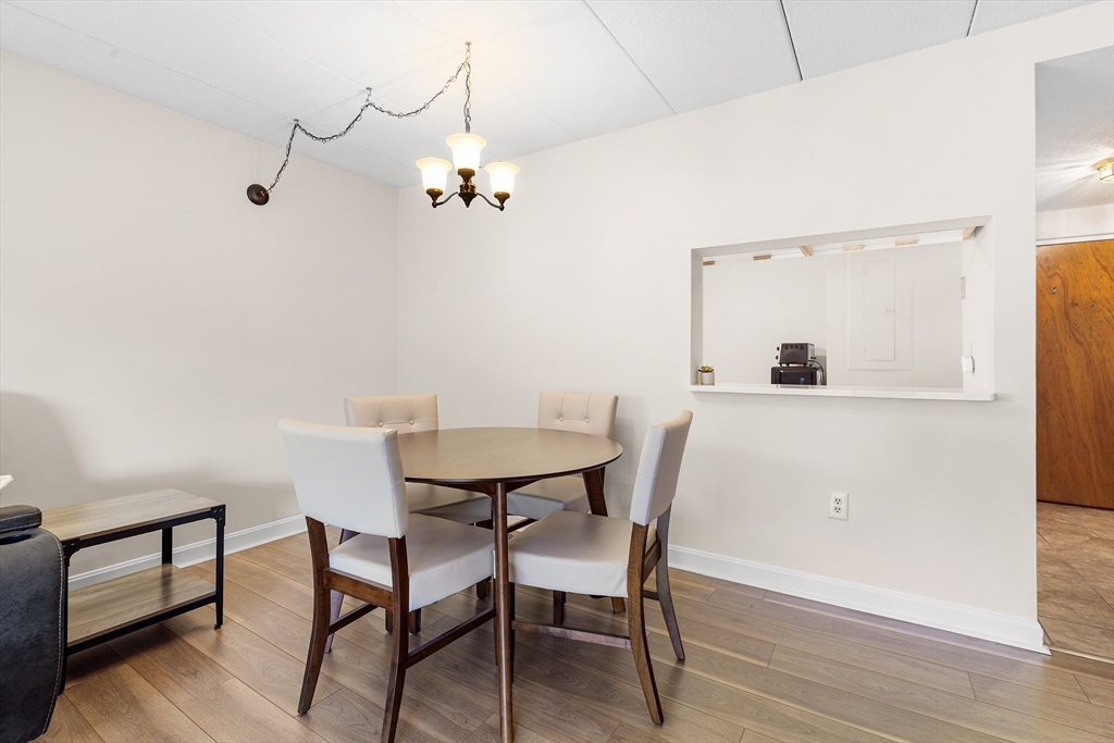 40 Main Street, Unit 505 Stoneham, MA 02180 - Photo 11 of 27 a view of a dining room with furniture and wooden floor