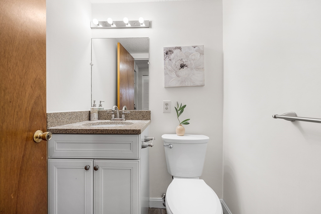 40 Main Street, Unit 505 Stoneham, MA 02180 - Photo 12 of 27 a bathroom with a toilet a sink and mirror