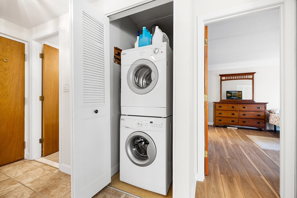 40 Main Street, Unit 505 Stoneham, MA 02180 - Photo 16 of 27 a view of a bedroom with washer and dryer