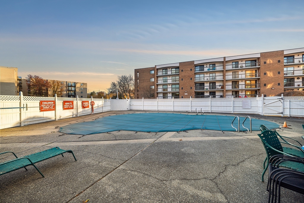 40 Main Street, Unit 505 Stoneham, MA 02180 - Photo 20 of 27 a view of a swimming pool and a porch