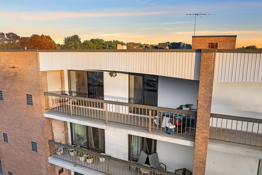 40 Main Street, Unit 505 Stoneham, MA 02180 - Photo 23 of 27 a terrace of a house with outdoor seating and lake view