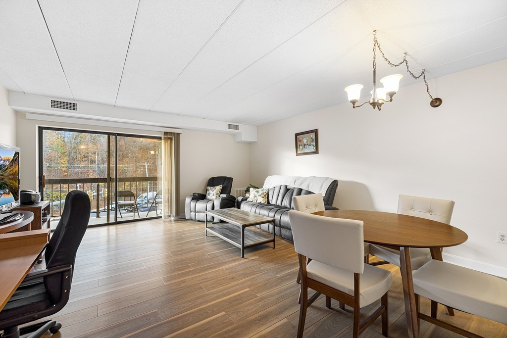 40 Main Street, Unit 505 Stoneham, MA 02180 - Photo 5 of 27 a living room with furniture a floor to ceiling window and wooden floor
