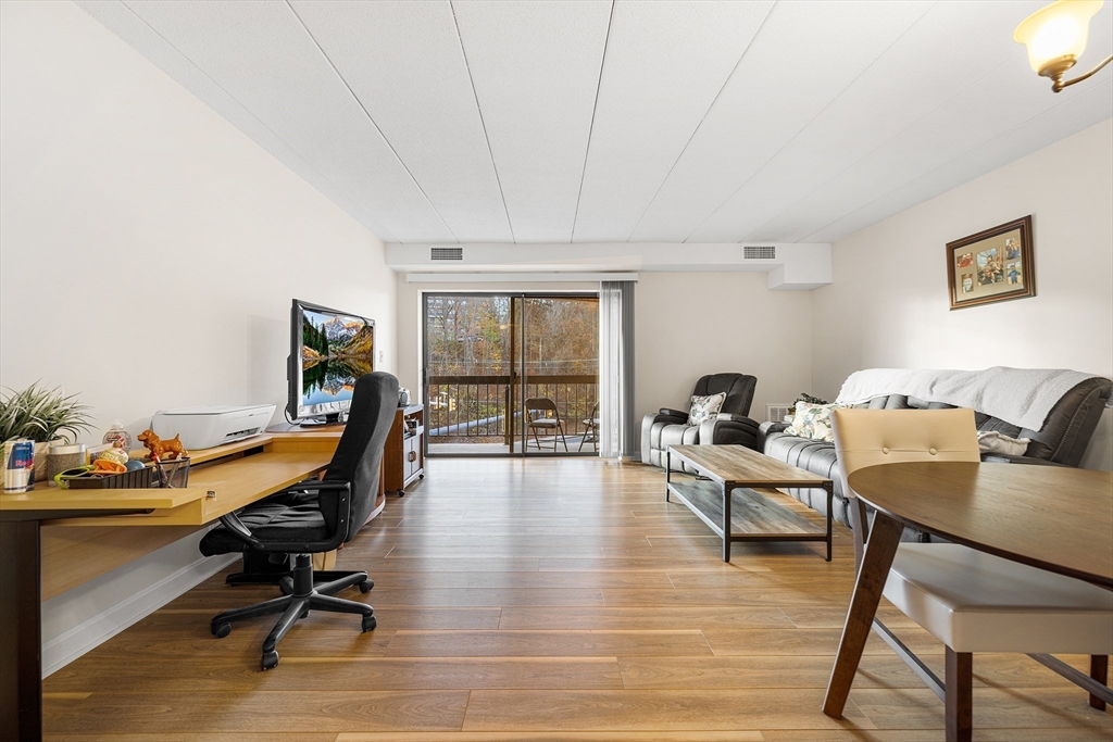 40 Main Street, Unit 505 Stoneham, MA 02180 - Photo 6 of 27 a view of a workspace with furniture and a window