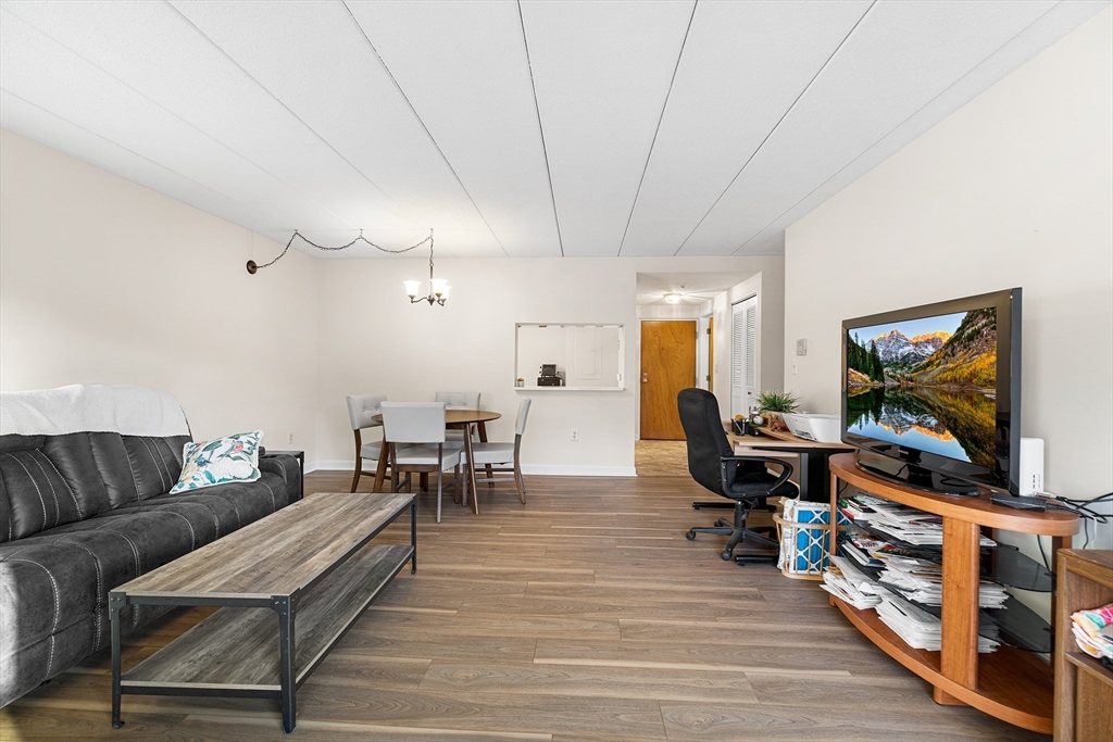 40 Main Street, Unit 505 Stoneham, MA 02180 - Photo 7 of 27 a living room with furniture and a flat screen tv