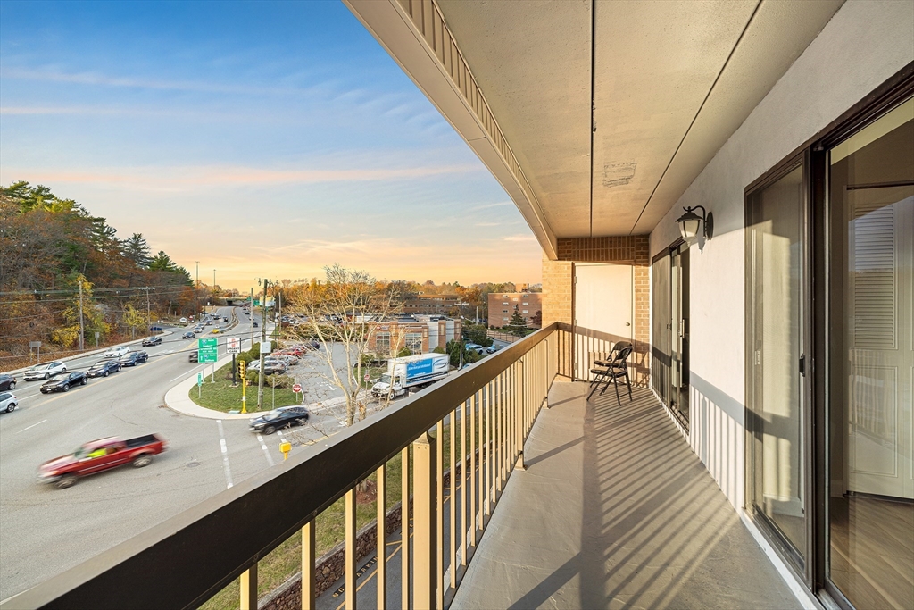 40 Main Street, Unit 505 Stoneham, MA 02180 - Photo 10 of 27 a view of a balcony with couches and wooden floor