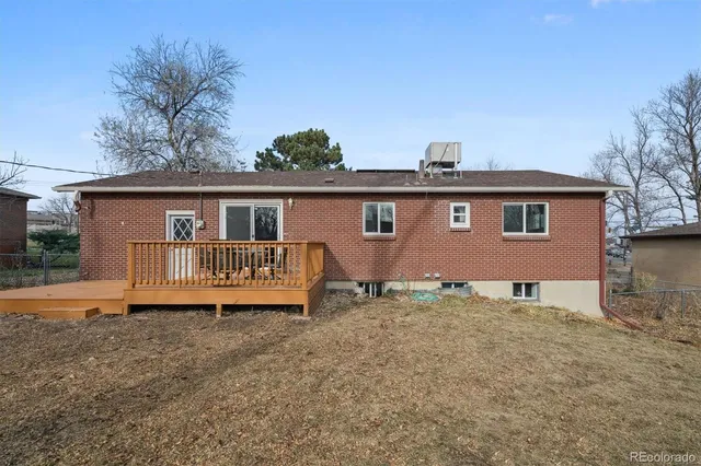 a front view of a house with a garden and yard