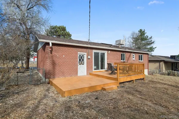 a view of a house with a yard and wooden fence