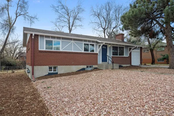 a front view of house with a garden