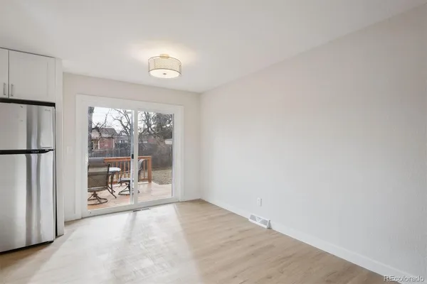 an empty room with floor to ceiling window and an outdoor view