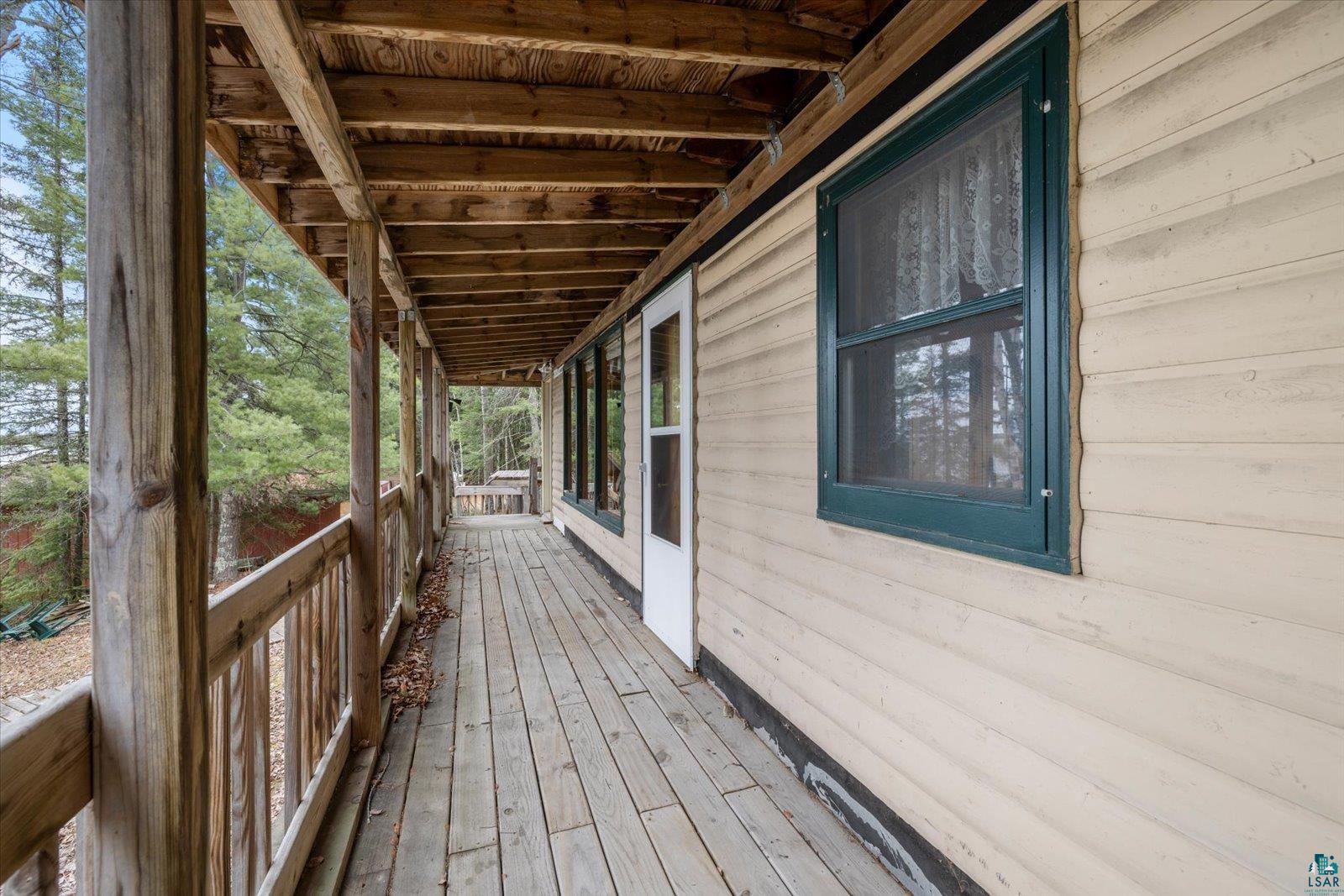 2014 West Frazer Bay Road Cook, MN 55723 - Photo 23 of 26 Expansive wood deck with natural wood railing and support beams