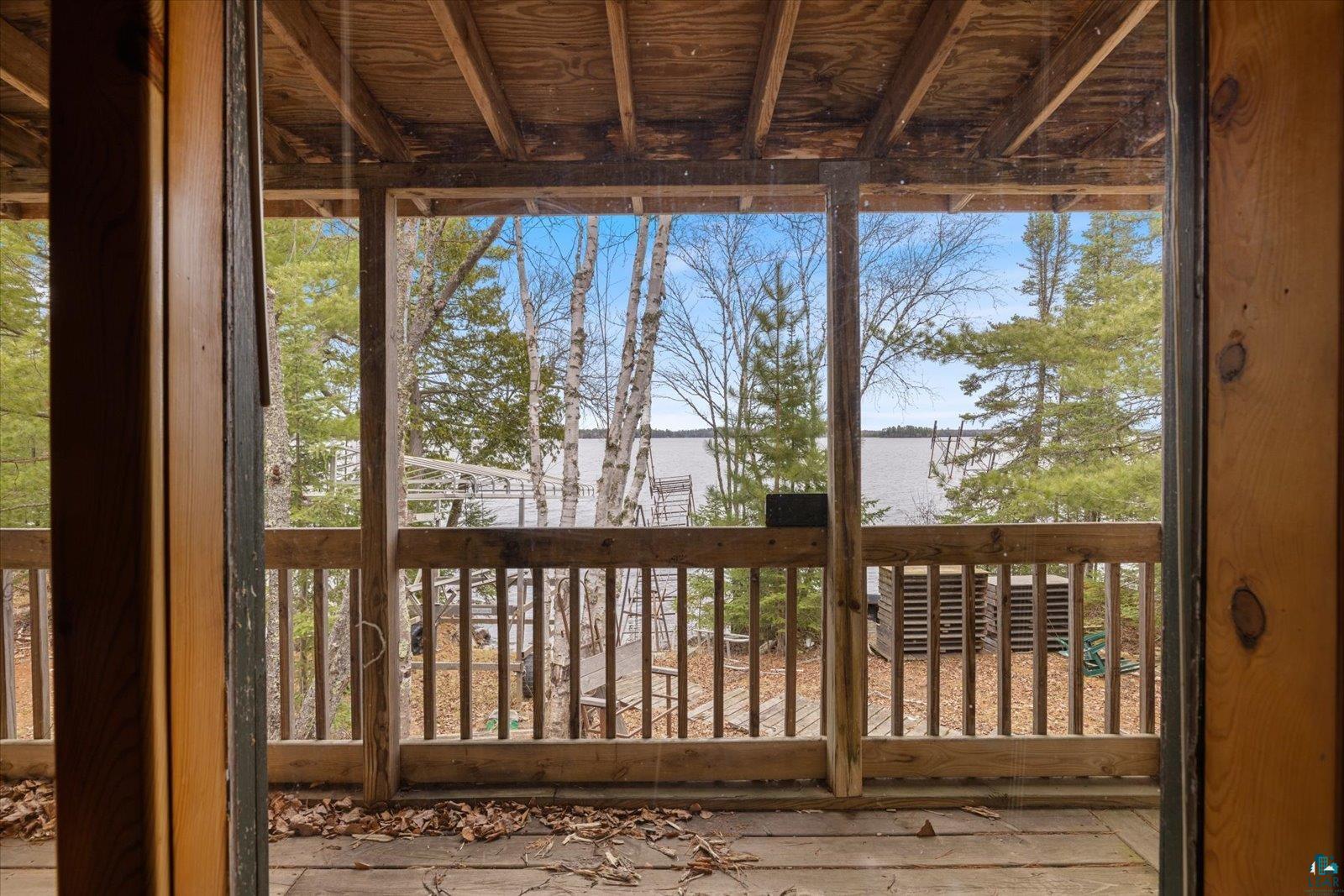 2014 West Frazer Bay Road Cook, MN 55723 - Photo 6 of 26 Screened porch with wood-finish flooring and a wood ceiling, offering expansive water scenery
