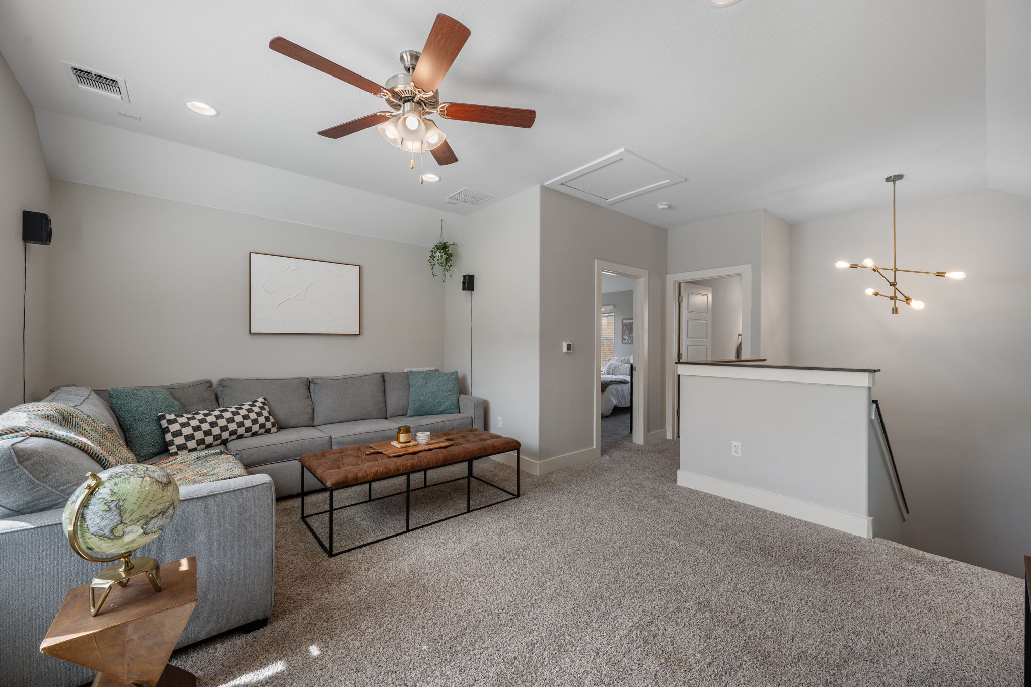 5409 Fox Wing Way Austin, TX 78747 - Photo 16 of 26 Relax in this inviting living area featuring soft carpet, a contemporary ceiling fan, and recessed lighting.