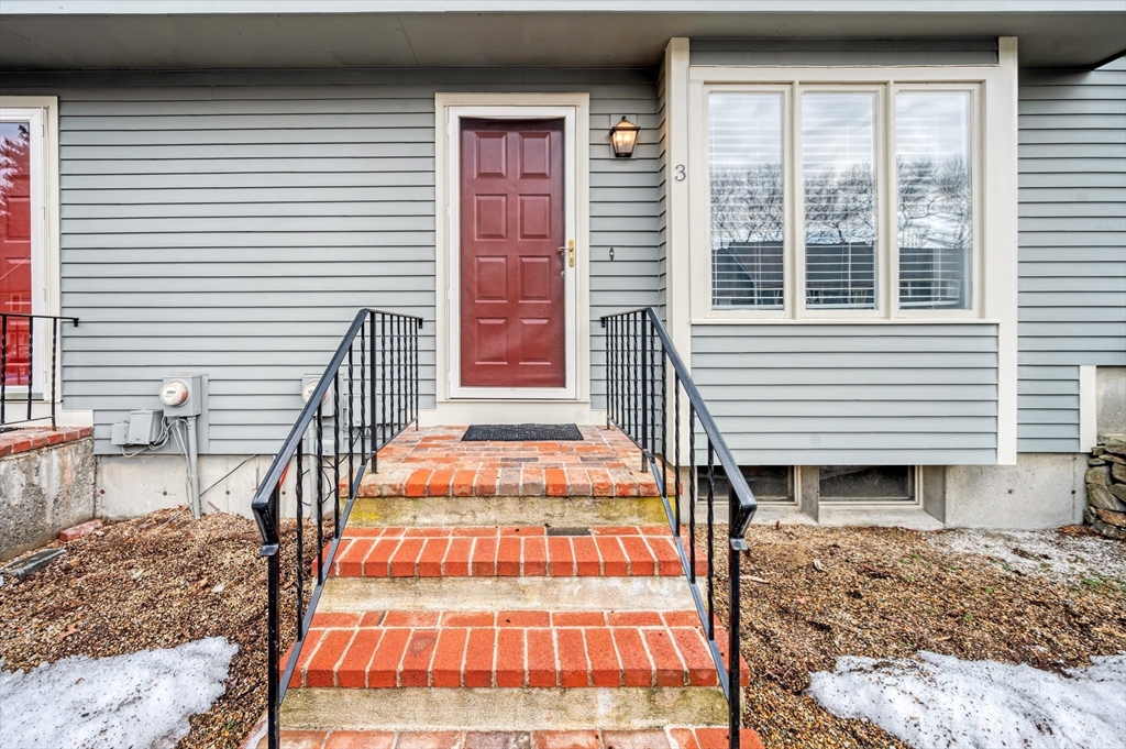 4 Deer Path, Unit 3 Maynard, MA 01754 - Photo 1 of 27 a backyard of a house with wooden fence and large windows