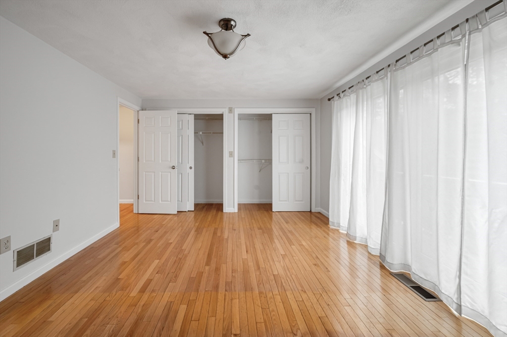 4 Deer Path, Unit 3 Maynard, MA 01754 - Photo 13 of 27 a view of an empty room with wooden floor