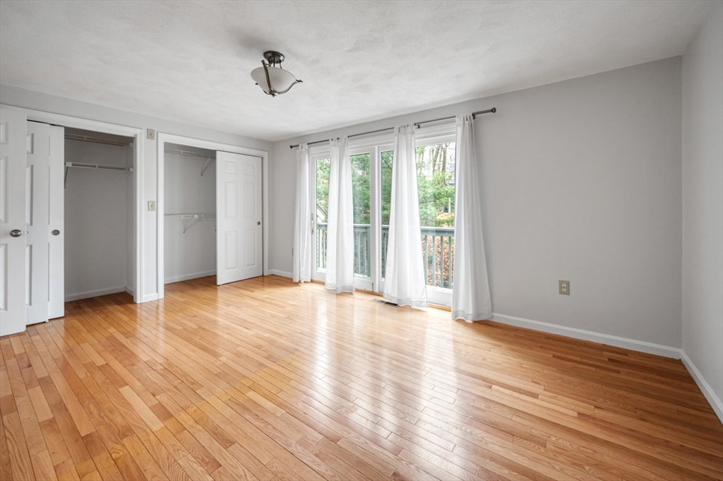 4 Deer Path, Unit 3 Maynard, MA 01754 - Photo 14 of 27 a view of an empty room with wooden floor and a window