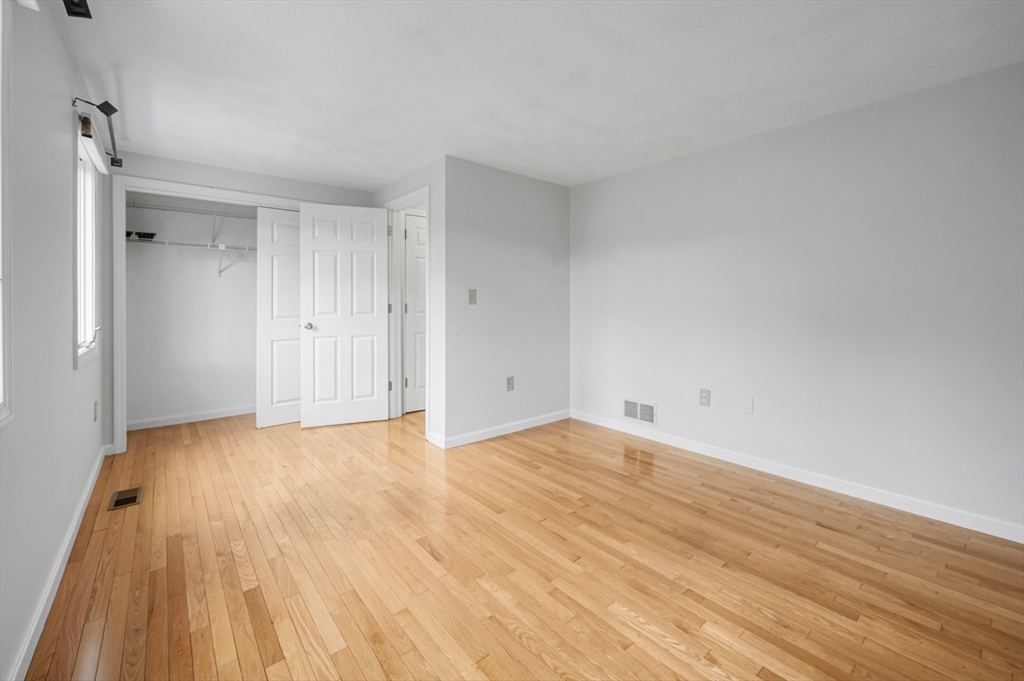 4 Deer Path, Unit 3 Maynard, MA 01754 - Photo 20 of 27 a view of an empty room and wooden floor