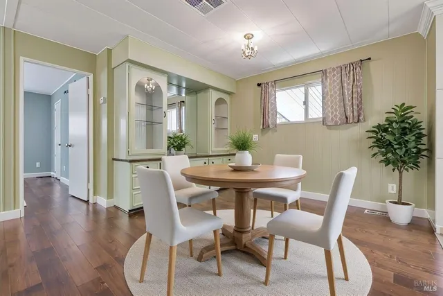 a view of a dining room with furniture window and wooden floor