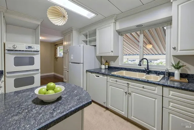 a kitchen with cabinets and window