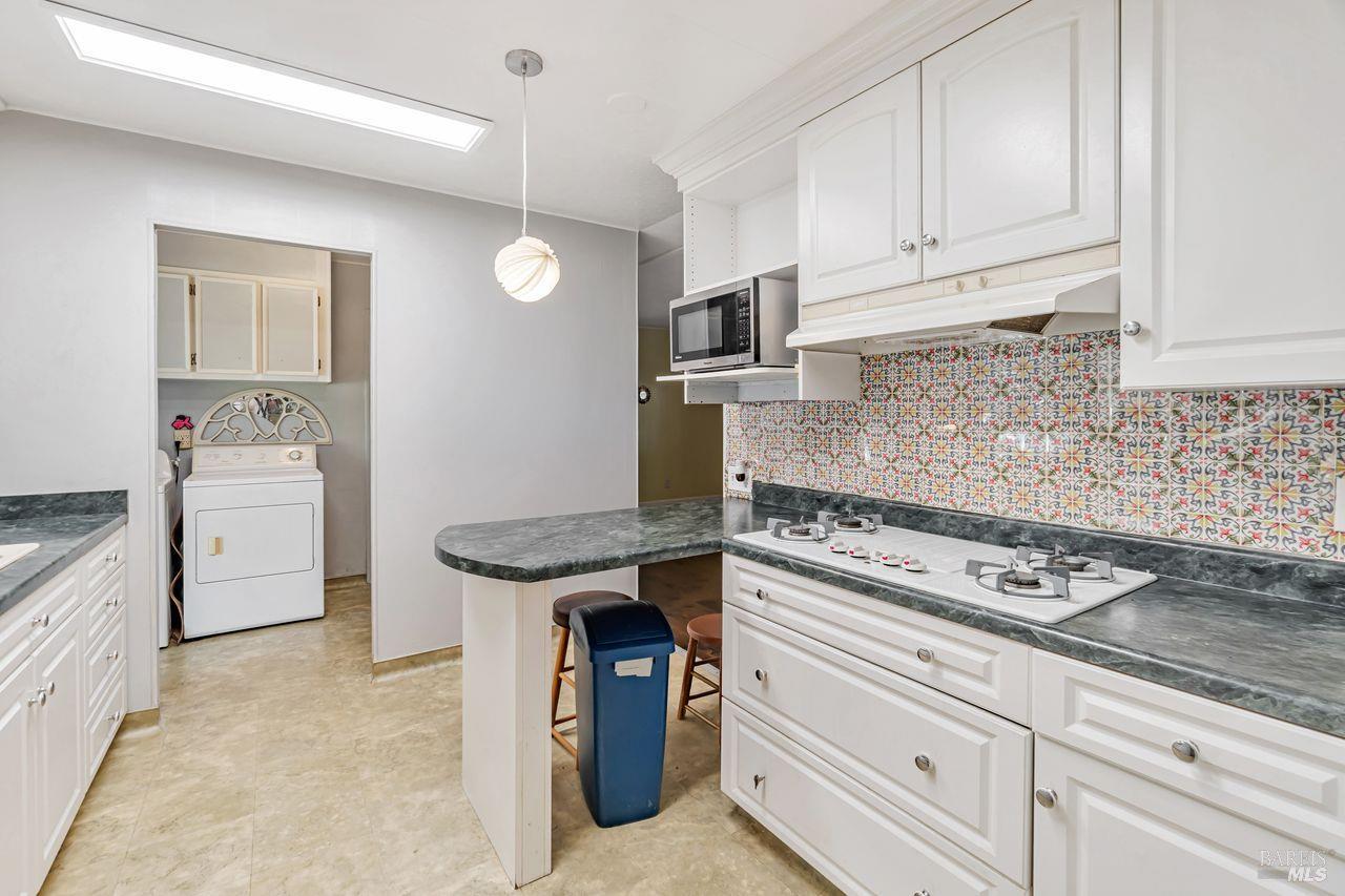 56 Club View Drive Novato, CA 94949 - Photo 3 of 27 a kitchen with granite countertop a sink stove and cabinets