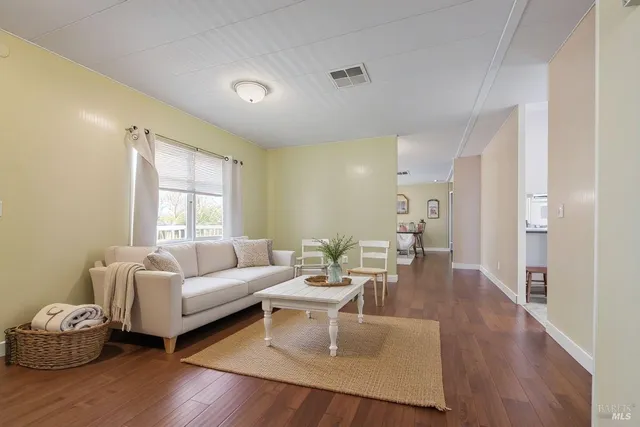 a living room with furniture window and wooden floor