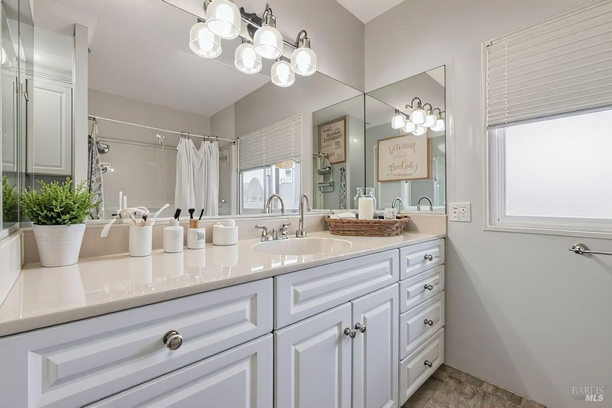 56 Club View Drive Novato, CA 94949 - Photo 10 of 27 a bathroom with a sink a large mirror and vanity