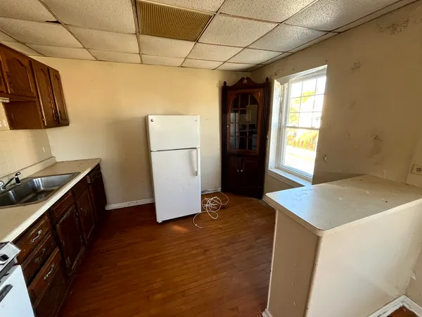 a kitchen with a refrigerator and a stove top oven