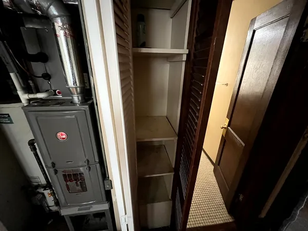 a view of walk in closet with clothes