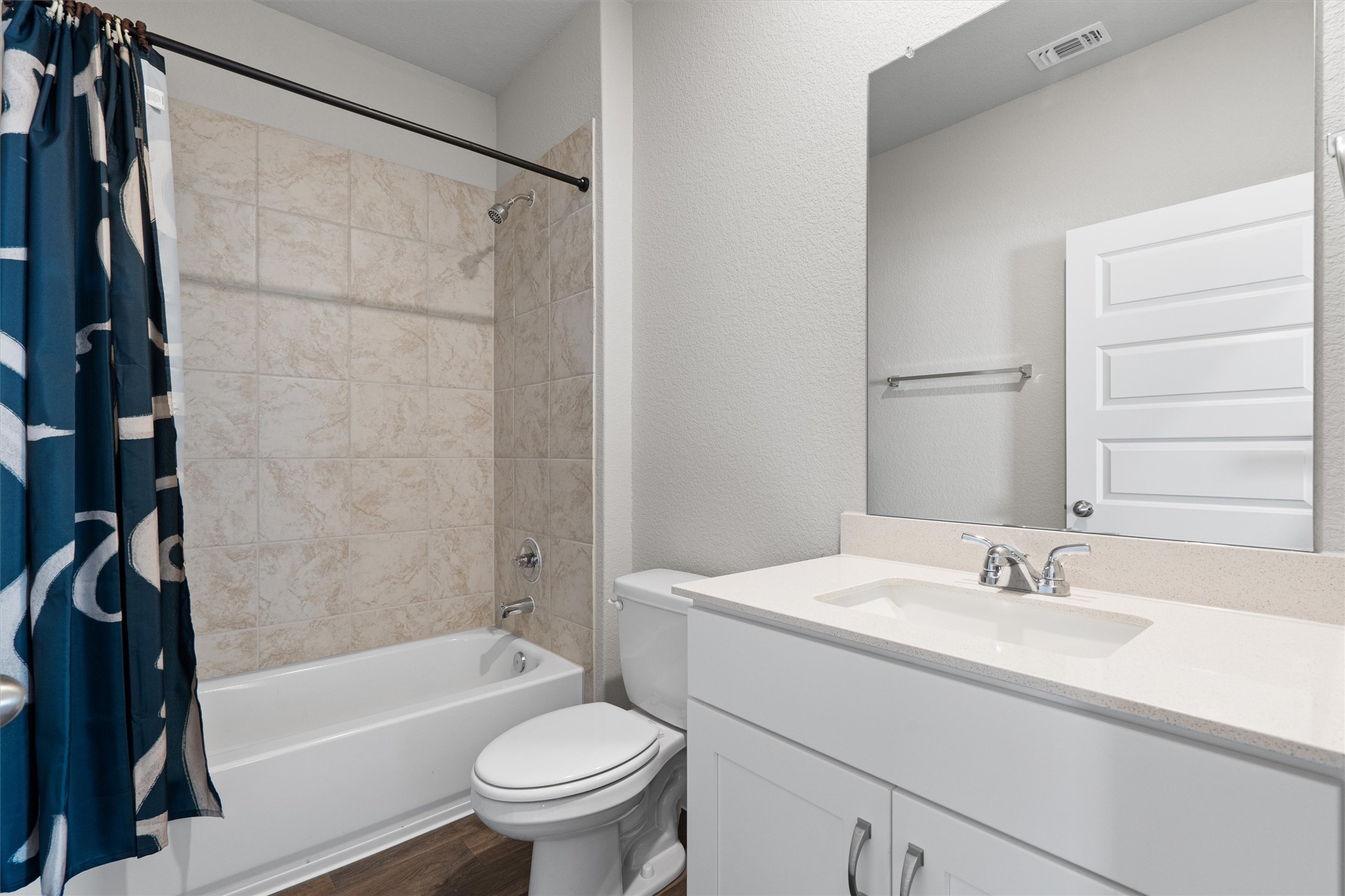 2606 Totley Road Manor, TX 78653 - Photo 16 of 28 a bathroom with a granite countertop sink toilet and shower