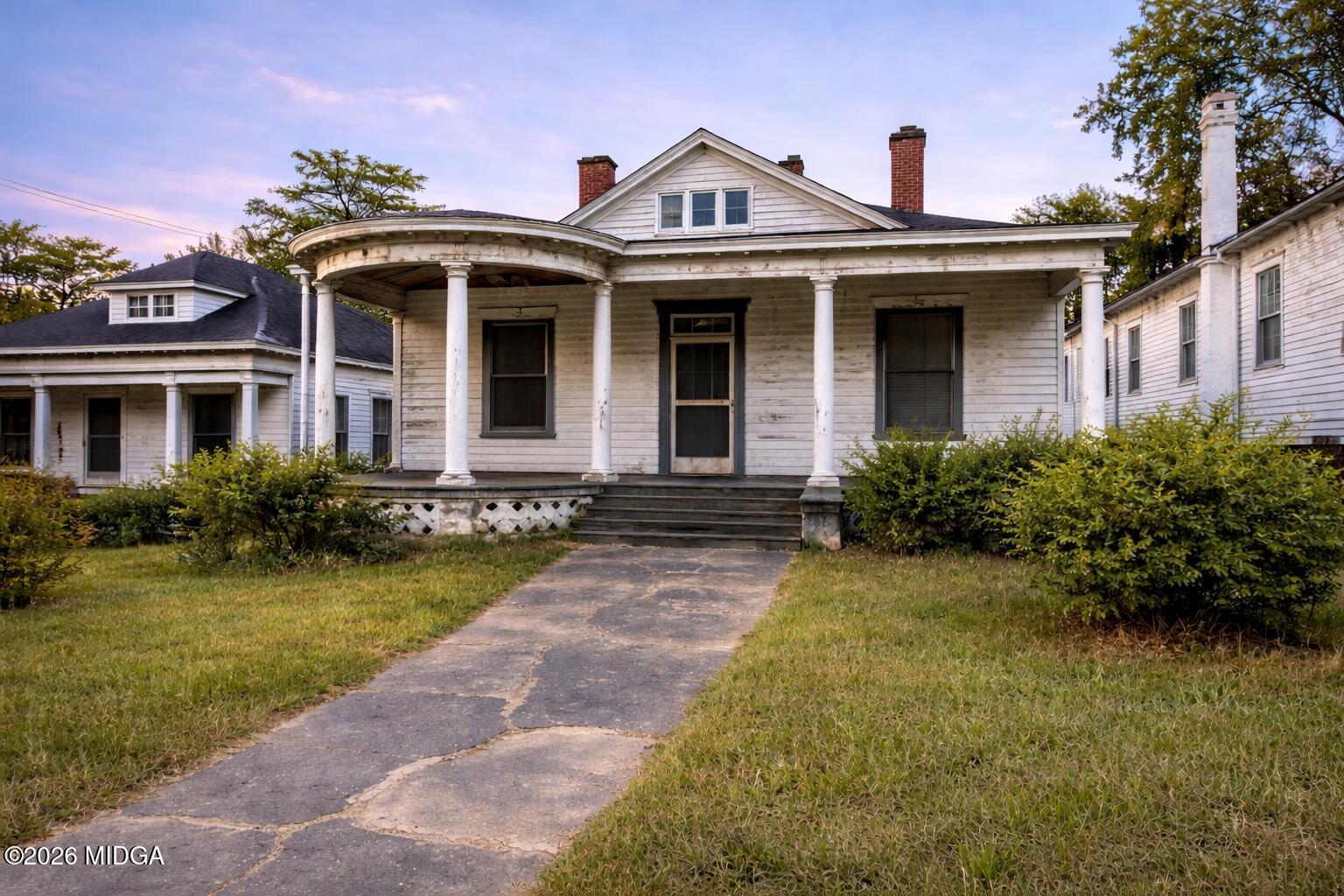 a front view of a house with garden