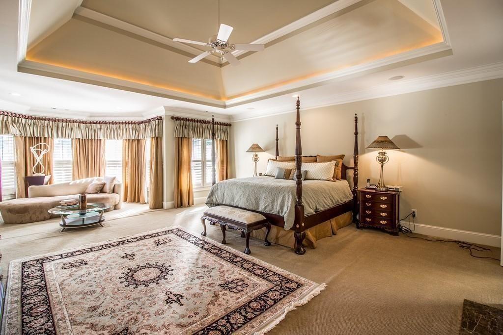 4064 Lyon Boulevard Southwest Atlanta, GA 30331 - Photo 17 of 38 a spacious bedroom with a bed a couch and large windows