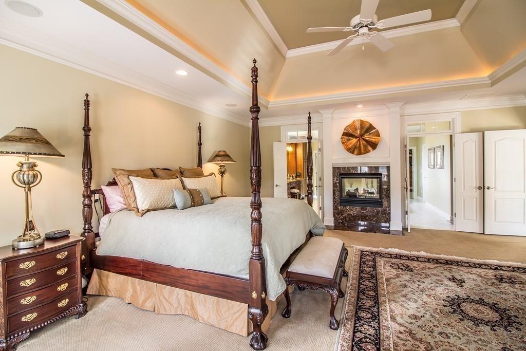 4064 Lyon Boulevard Southwest Atlanta, GA 30331 - Photo 18 of 38 a bed room with a bed and a fireplace