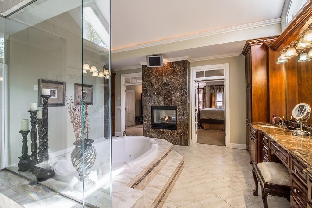 4064 Lyon Boulevard Southwest Atlanta, GA 30331 - Photo 21 of 38 a living room with furniture a fireplace and a chandelier