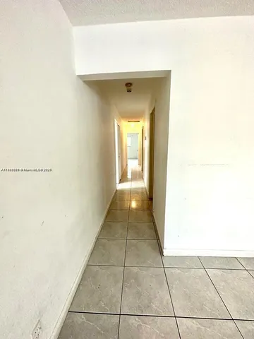 a hallway with sliding door and main door