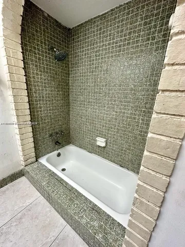 a bathroom with a bathtub and shower